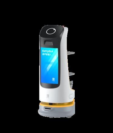 Bild eines Pudu Robotics Marketingroboters namens KettyBot, mit schlankem, hohem Design in Weiss und schwarzem Display, auf dem 'KettyBot' und chinesische Schriftzeichen angezeigt werden.